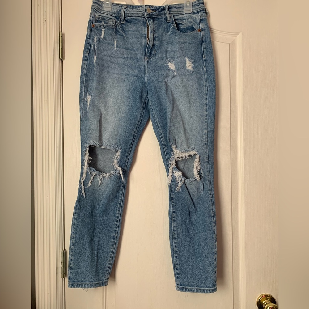 Cello women’s blue jeans with holes in the knees.